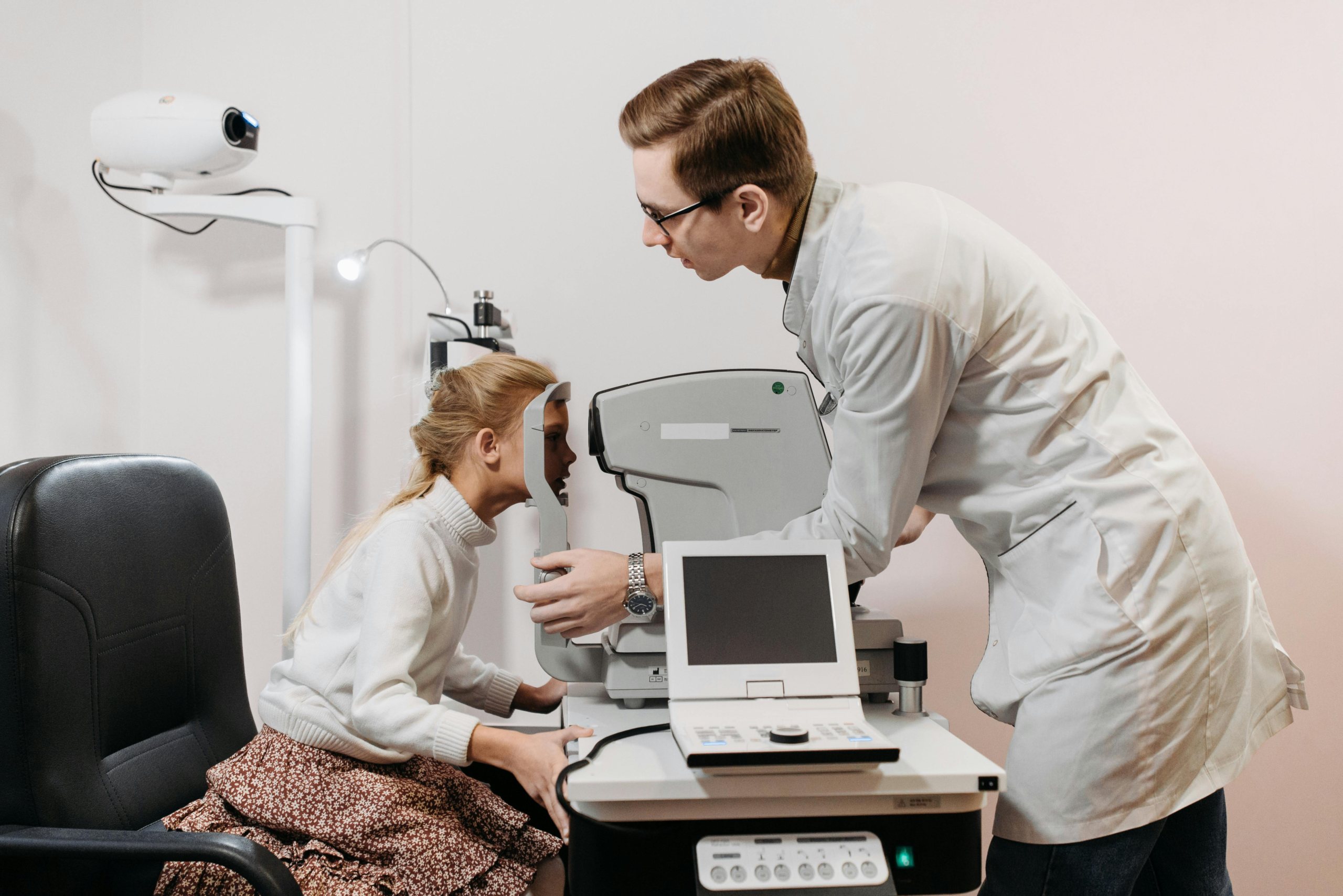 Doctor examining a patient’s eye with slit-lamp microscope to diagnose uveitis (eye inflammation)