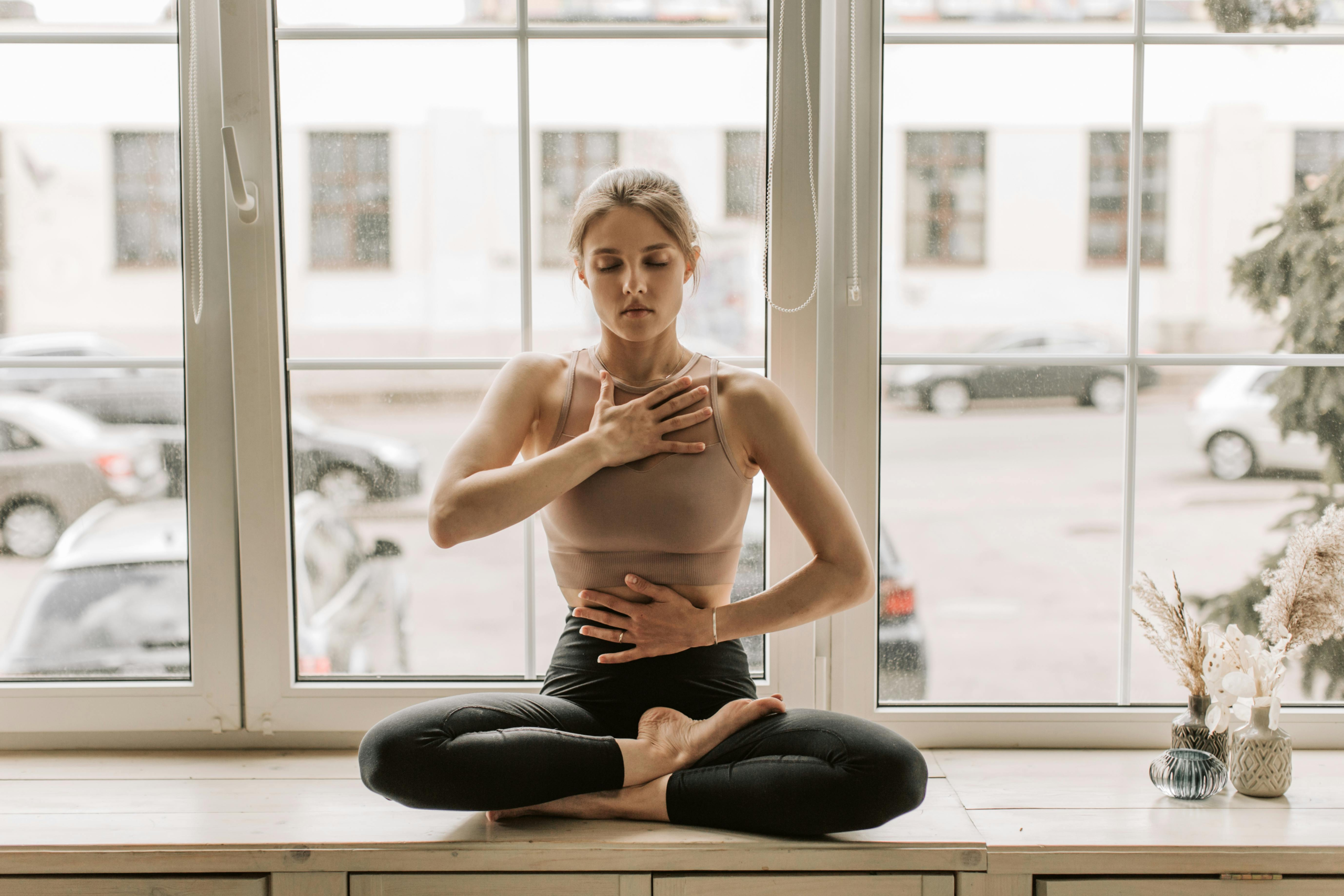 A woman meditating in natural light, symbolizing the mind–body connection for eye health