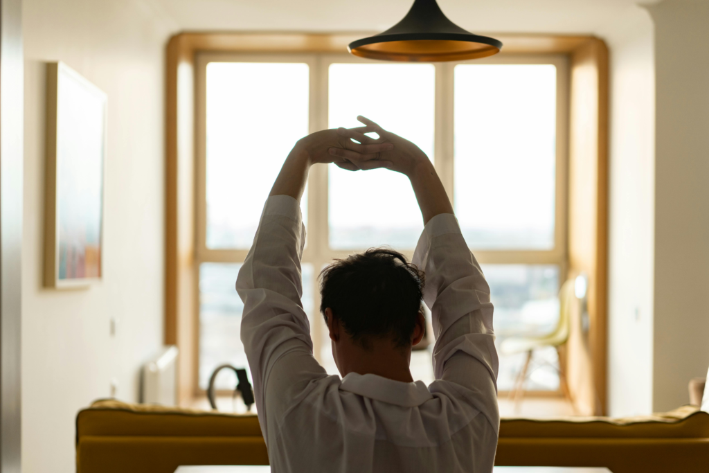 Person doing morning eye exercises near a window in natural light