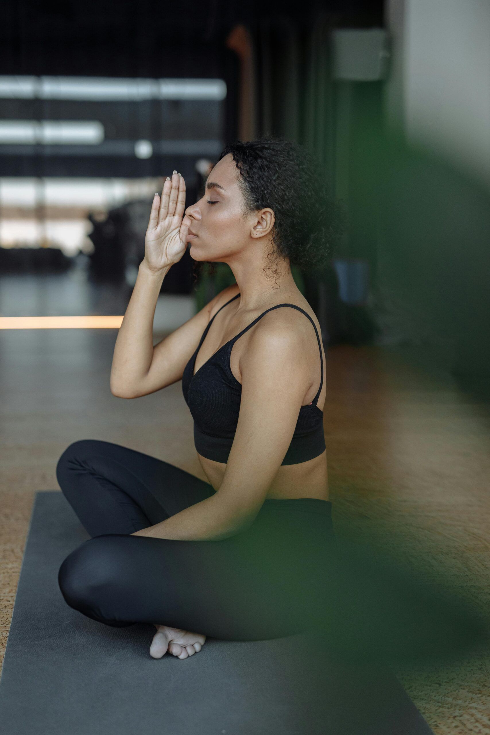 A woman performing morning eye exercises by the window to relax and refresh vision.