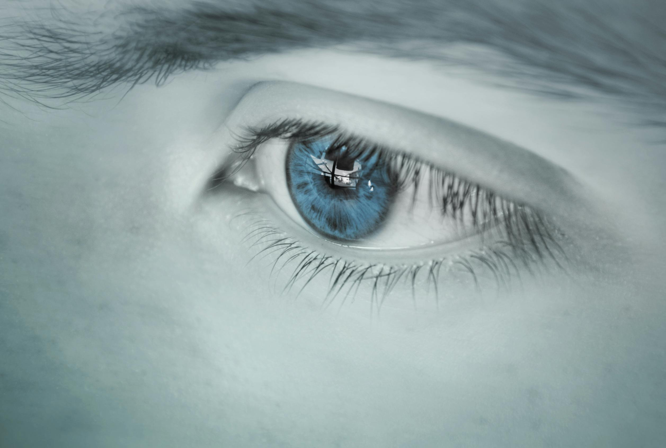 Close-up of a human blue eye representing clear vision and the importance of eye floaters awareness