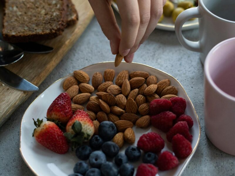 Person preparing a balanced meal rich in eye-healthy foods like salmon, spinach, carrots, and eggs — representing nutrition for better vision