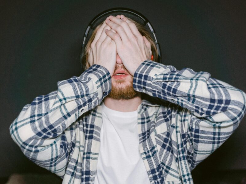 Man experiencing eye pain behind the eyes after prolonged screen use