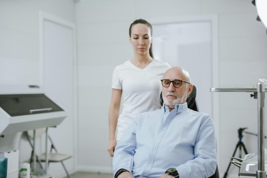 Adult patient discussing eye exam frequency and presbyopia with an optometrist.