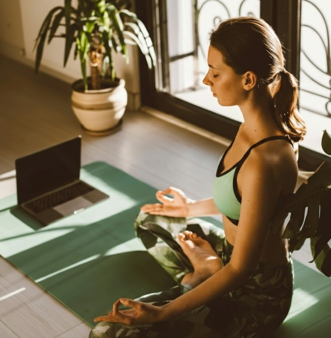 A woman practicing eye relaxation techniques as part of The Science of Blinking to prevent digital eye strain.
