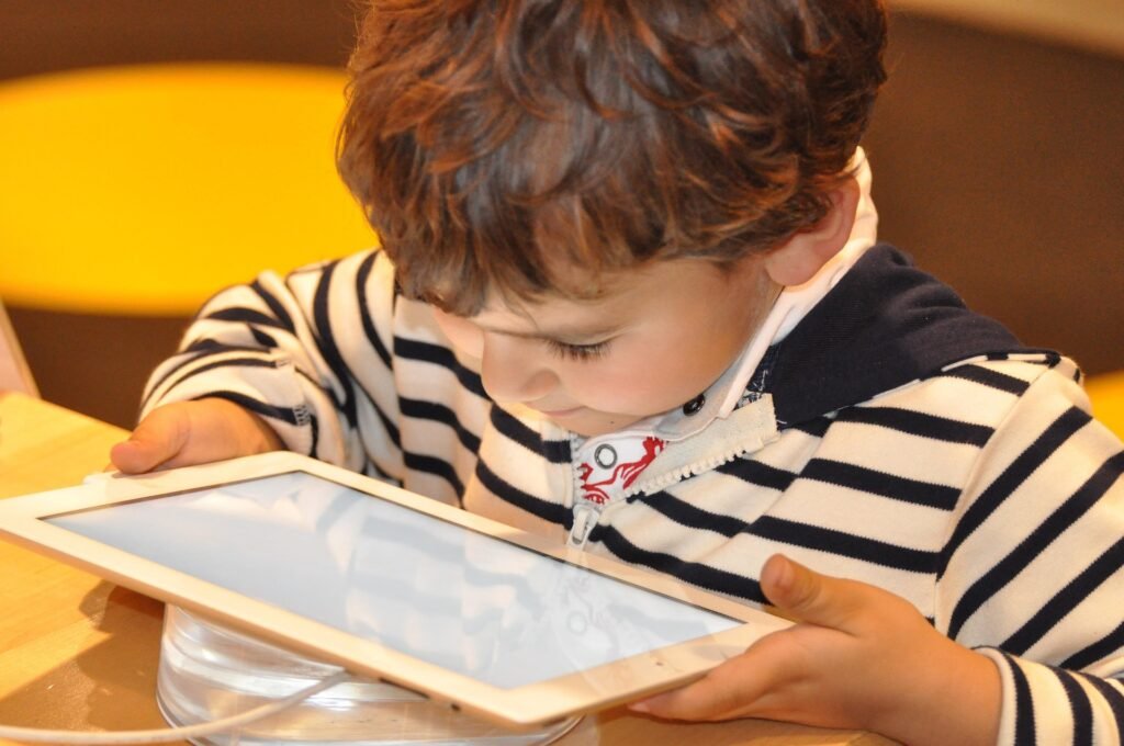A child using a smartphone tablet showing how screen time affects children's eye development.