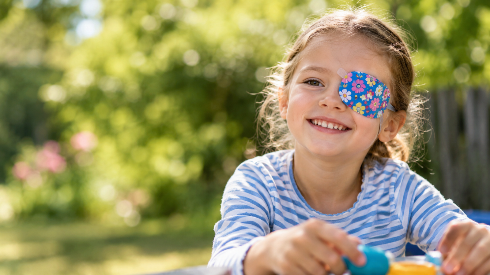 young girl undergoing occlusion therapy for lazy eye amblyopia with an eye patch