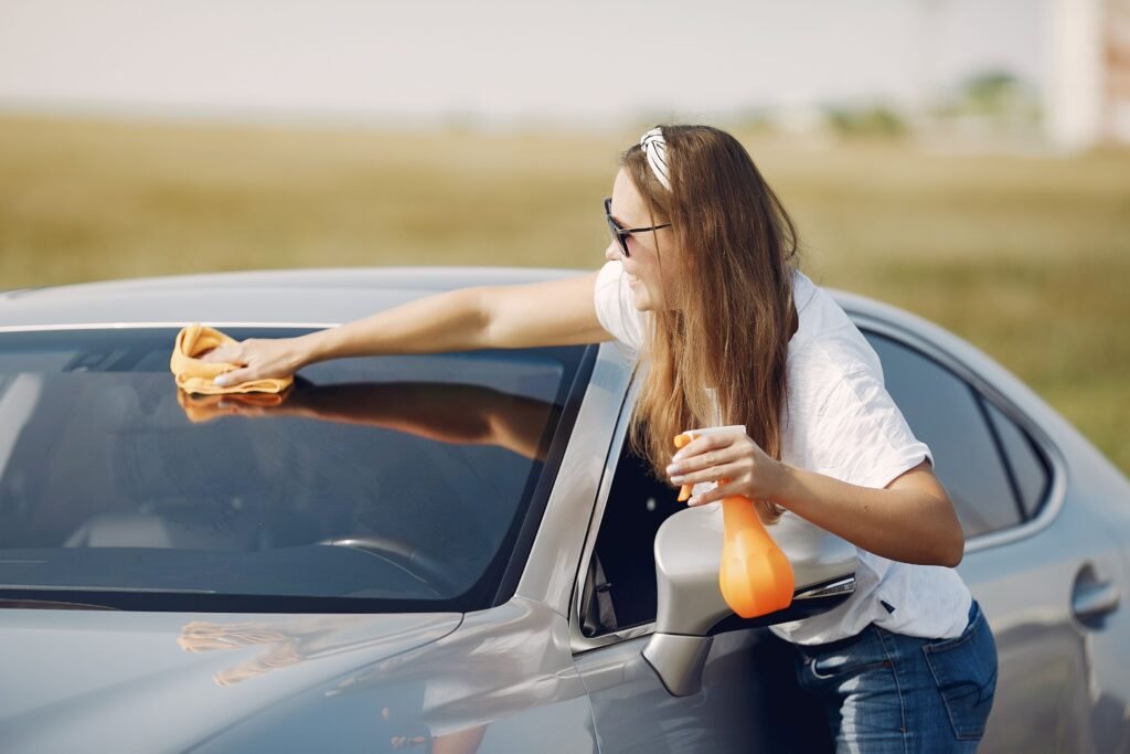 Cleaning the inside windshield to reduce glare halos and mitigate driving eye strain during long trips.