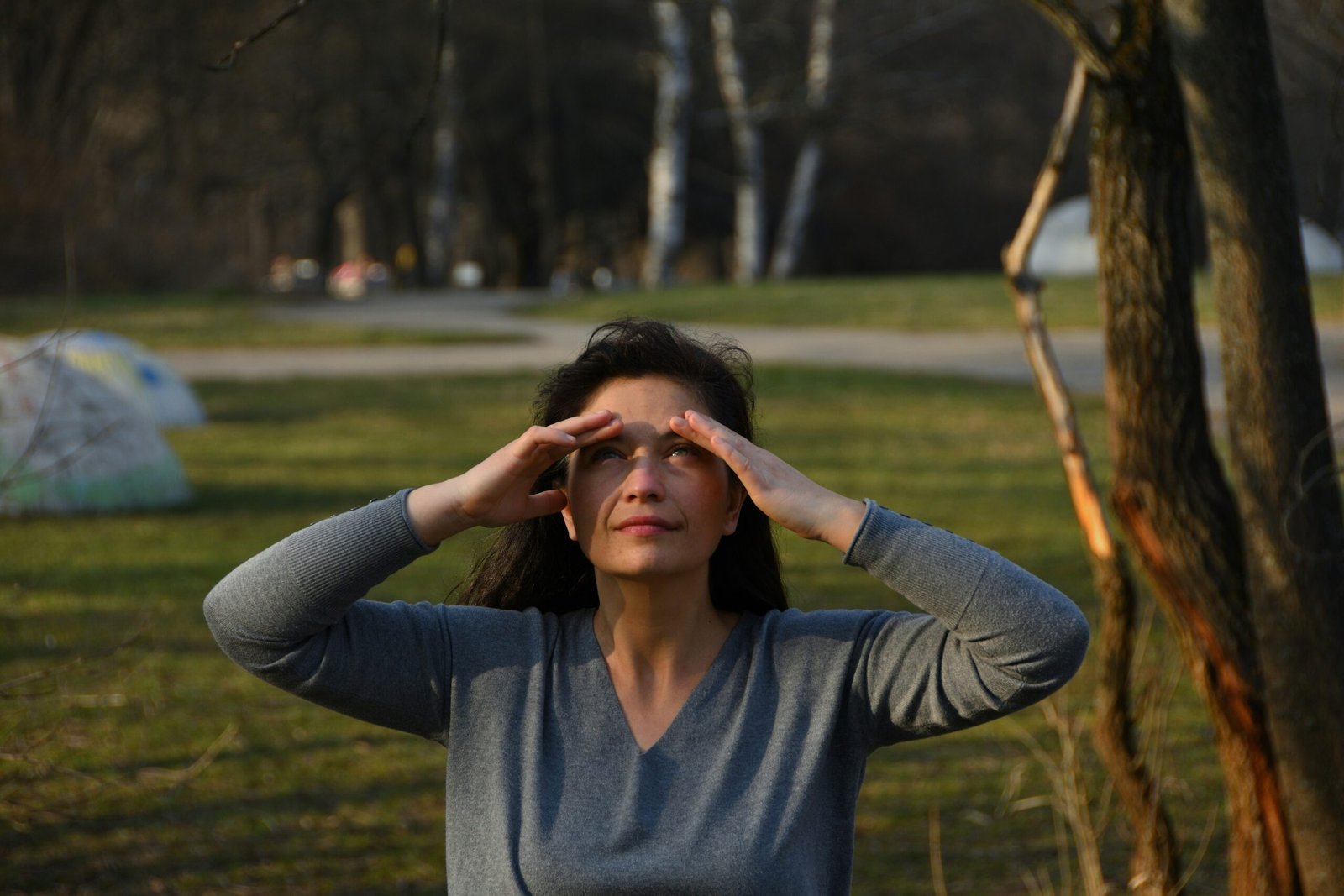 Person practicing natural eye exercises by looking outside to reduce eye strain and improve focus